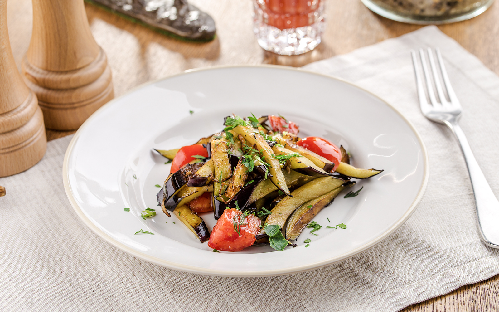 Grilled vegetables with herbs on a white plate for lunch.