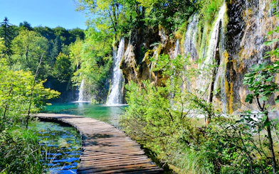 Boardwalk winding through waterfalls at Plitvice Lakes National Park, Croatia.