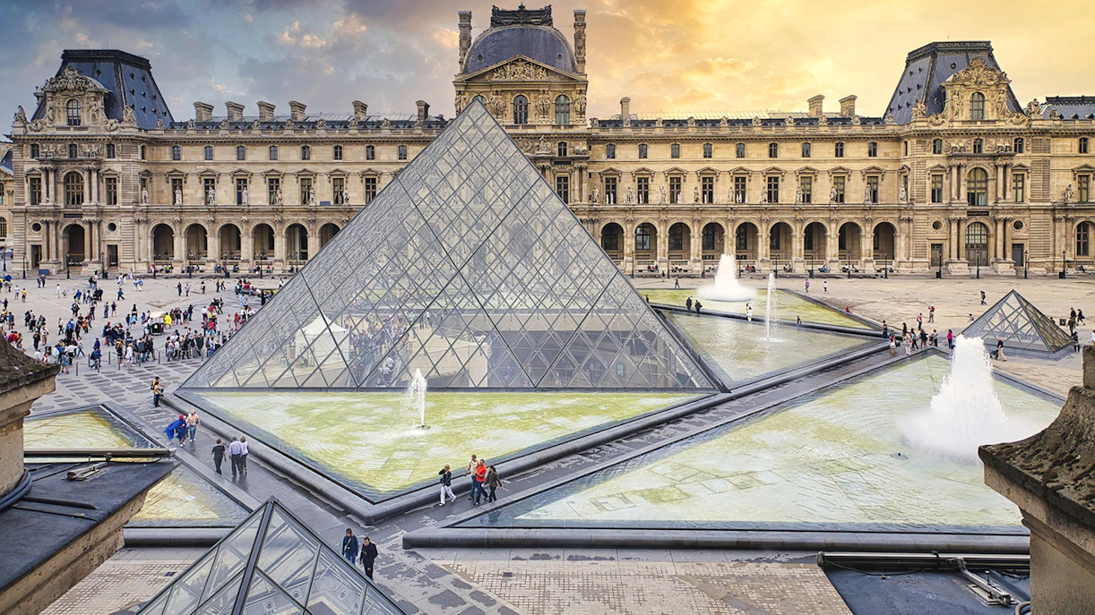 Louvre Museum courtyard with glass pyramid and fountains, Paris, France.