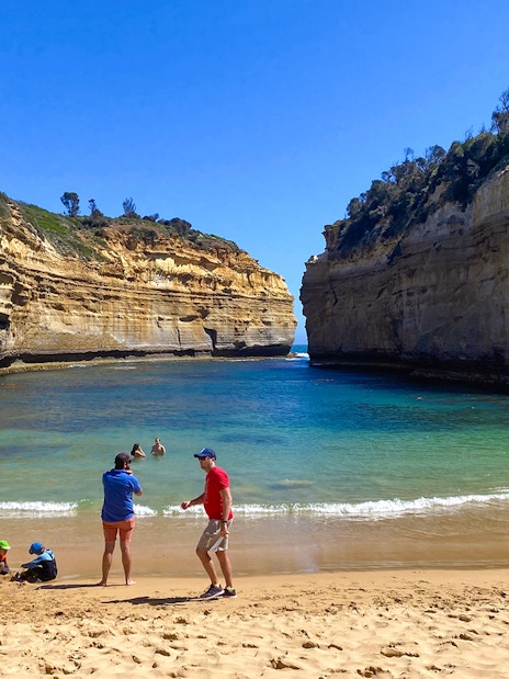 Visitors enjoying Loch Ard Gorge beach on the Great Ocean Road Day Tour.