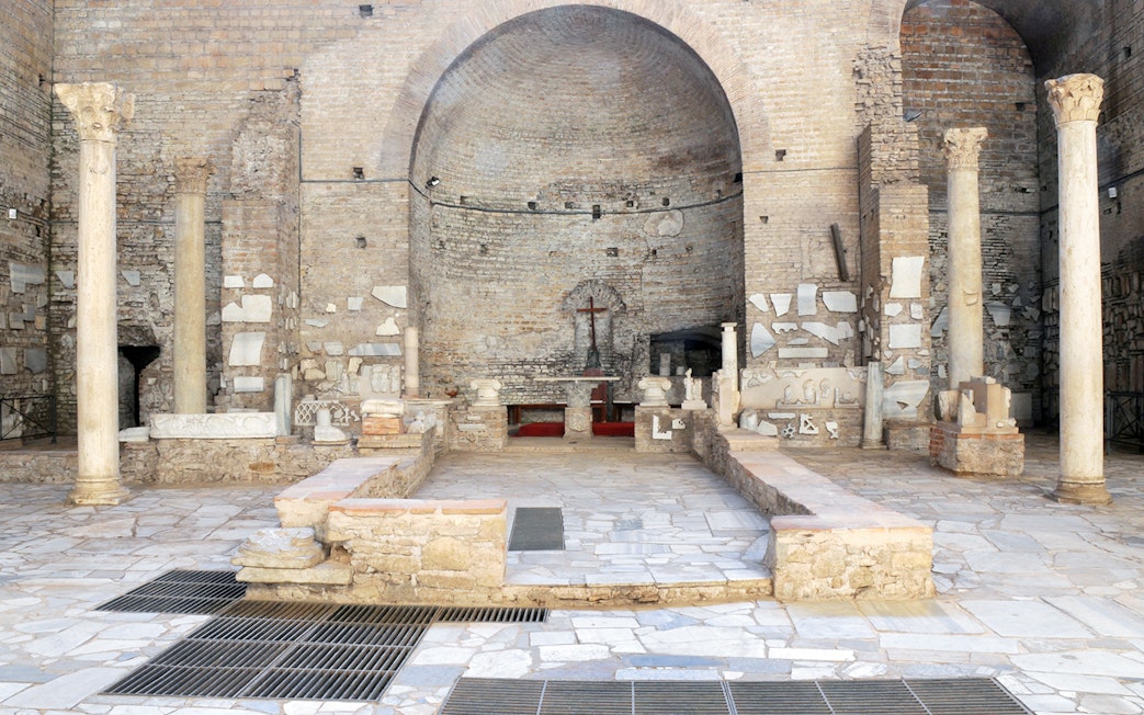 Catacombs of Domitilla interior with ancient columns and altar, Rome guided tour.