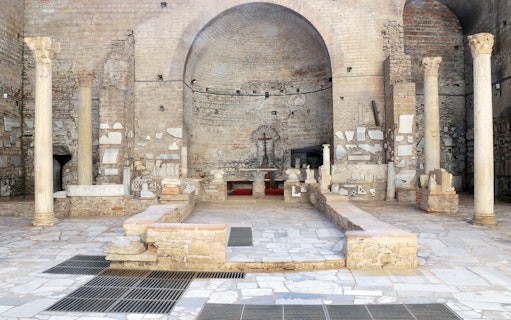 Catacombs of Domitilla interior with ancient columns and altar, Rome guided tour.