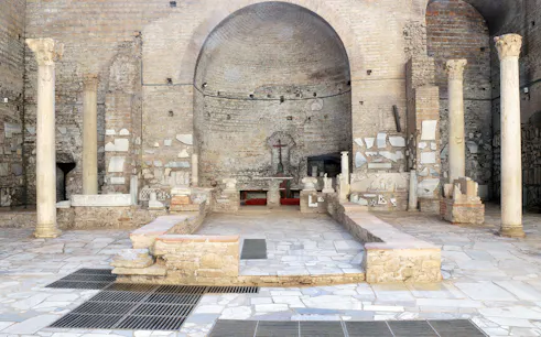 Catacombs of Domitilla interior with ancient columns and altar, Rome guided tour.