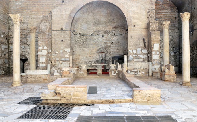 Catacombs of Domitilla interior with ancient columns and altar, Rome guided tour.