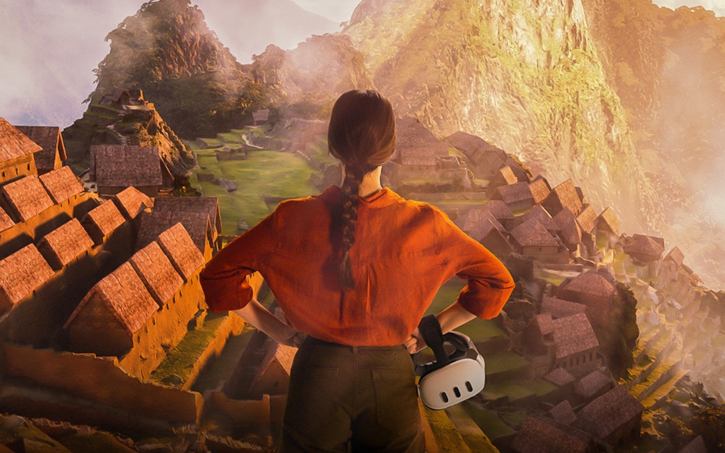 Person viewing Machu Picchu ruins with virtual reality headset in hand.