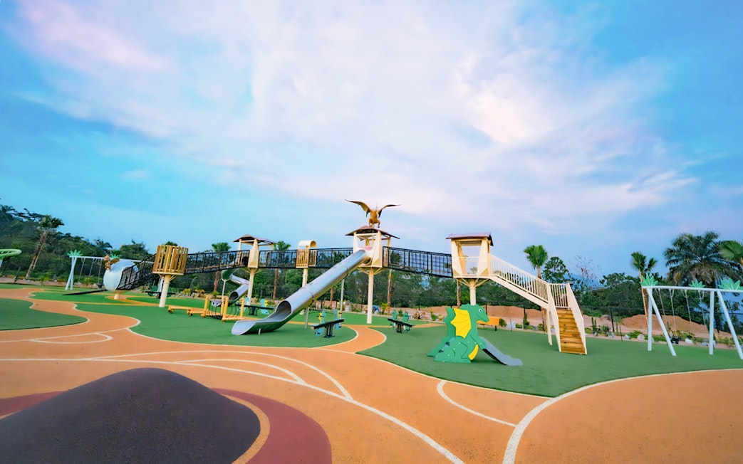 Playground with dinosaur-themed slides and climbing structures at Dino Desert.