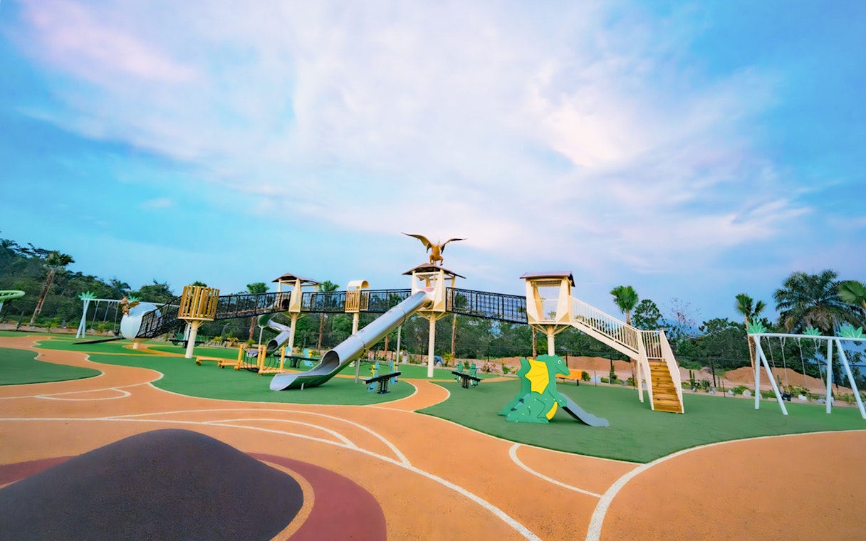 Playground with dinosaur-themed slides and climbing structures at Dino Desert.