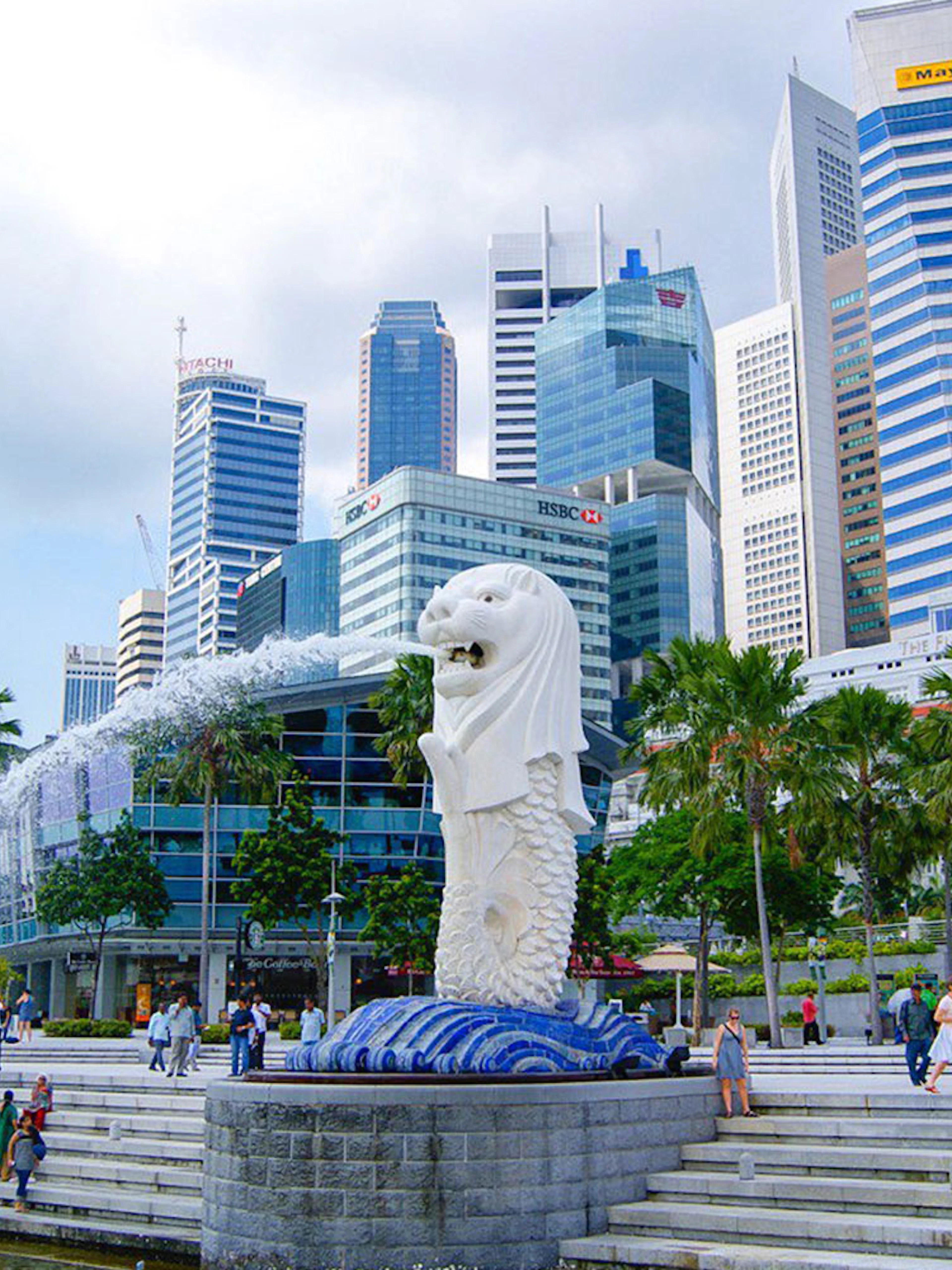 Merlion statue with Singapore skyline in the background at Marina Bay.