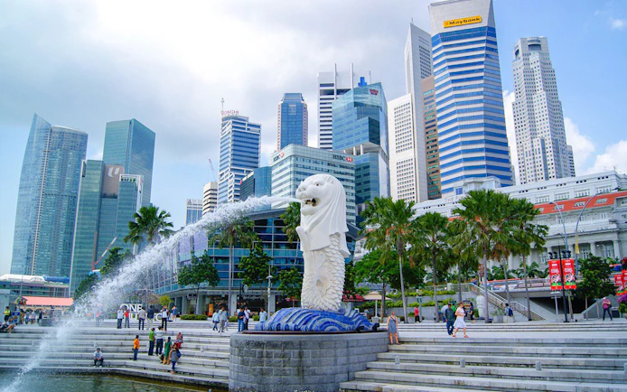 Merlion statue with Singapore skyline in the background at Marina Bay.