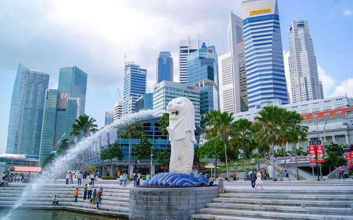 Merlion statue with Singapore skyline in the background at Marina Bay.