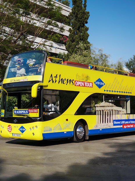 Athens open-top tour bus on city street, part of Turbopass Athens City Pass.