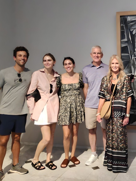 Tourists with guide at Picasso Museum viewing a black and white painting.