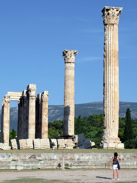 Ancient Temple of Olympian Zeus ruins in Athens with tourists exploring.