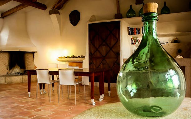 Argiolas Winery tasting room with large green glass bottle, Serdiana tour.