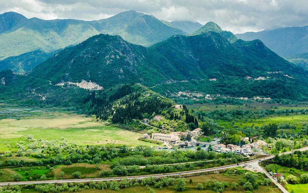 Virpazar village surrounded by lush mountains at Lake Skadar National Park.