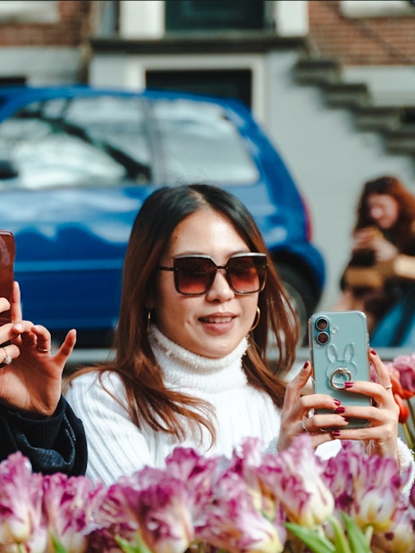 Guests photographing tulips on luxury cruise in Amsterdam.