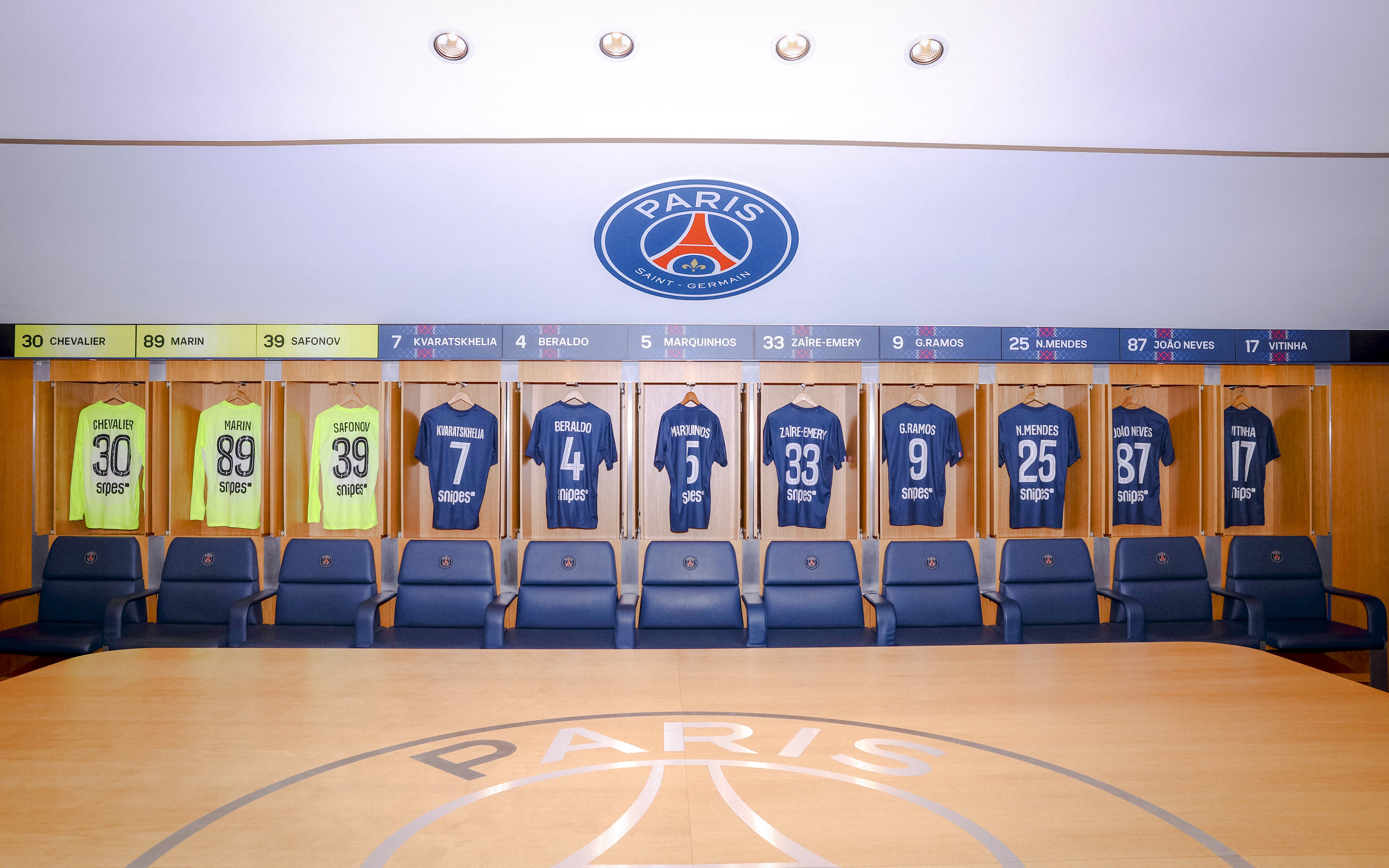 PSG Stadium locker room with player jerseys in Paris, France.