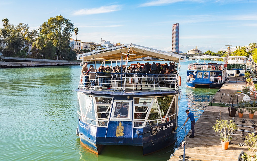 People disembarking from a cruise boat on the Guadalquivir River in Seville, Spain.