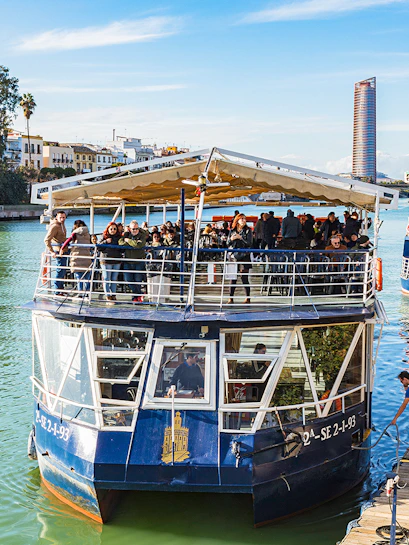 People disembarking from a cruise boat on the Guadalquivir River in Seville, Spain.