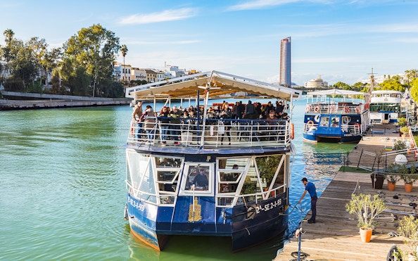 People disembarking from a cruise boat on the Guadalquivir River in Seville, Spain.