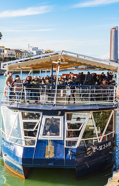 People disembarking from a cruise boat on the Guadalquivir River in Seville, Spain.