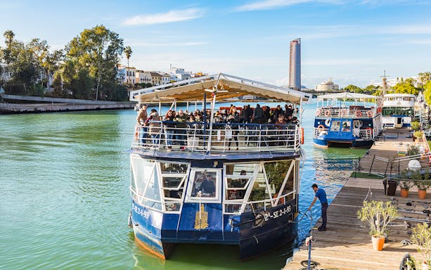 People disembarking from a cruise boat on the Guadalquivir River in Seville, Spain.