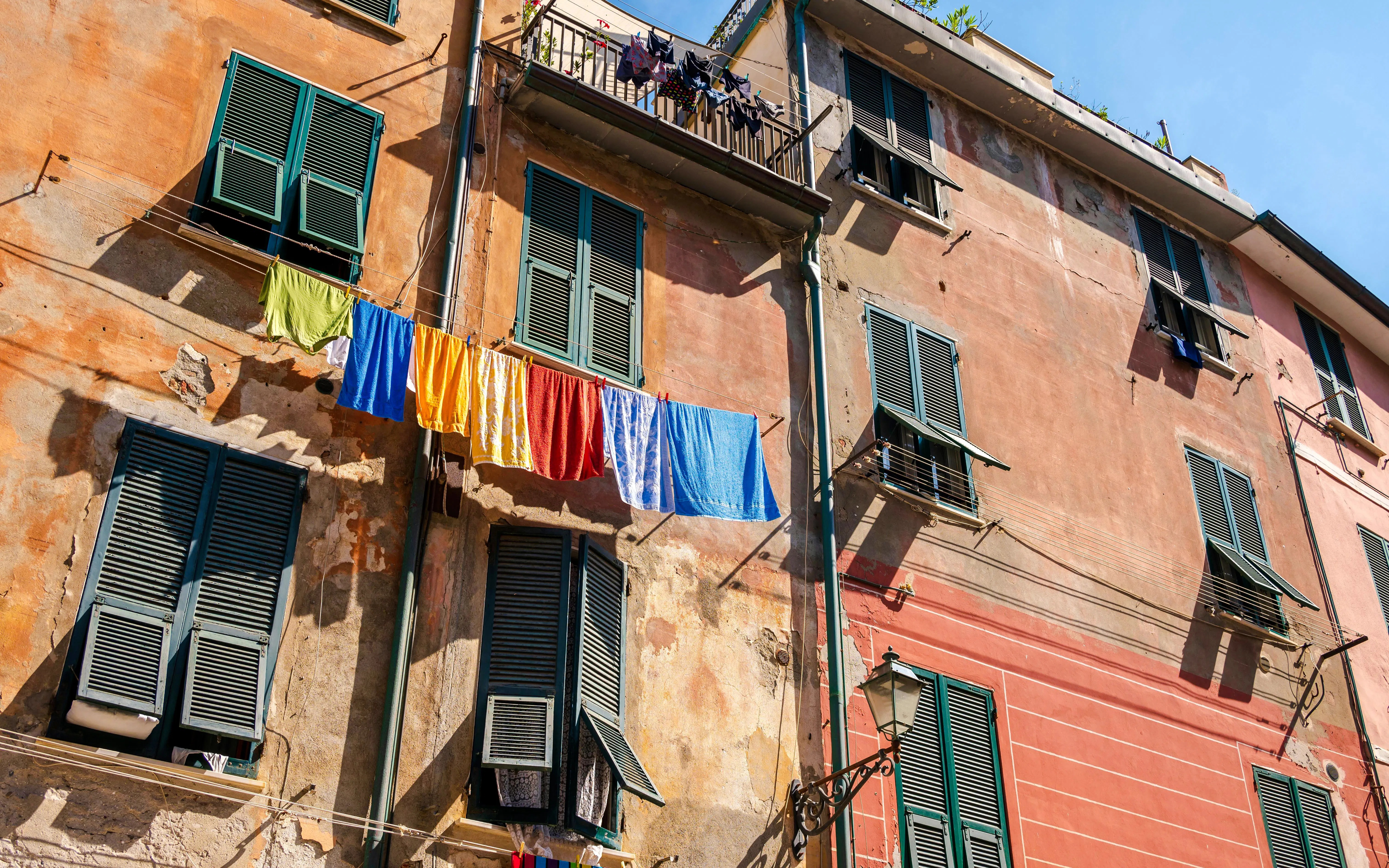 Towels hanging on clotheslines along Via Roma in Vernazza, Italy.