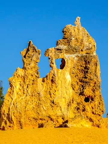 Pinnacles Desert limestone formations under clear blue sky in Western Australia.