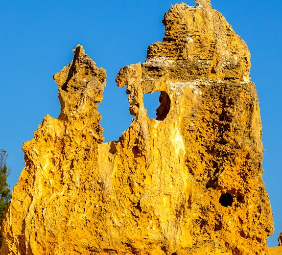 Pinnacles Desert limestone formations under clear blue sky in Western Australia.