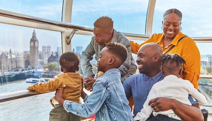 Family enjoying the view of Big Ben from a London Eye capsule.