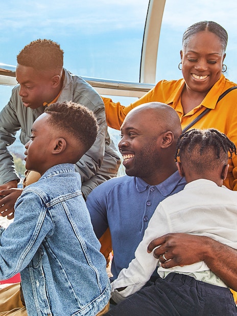 Family enjoying the view of Big Ben from a London Eye capsule.