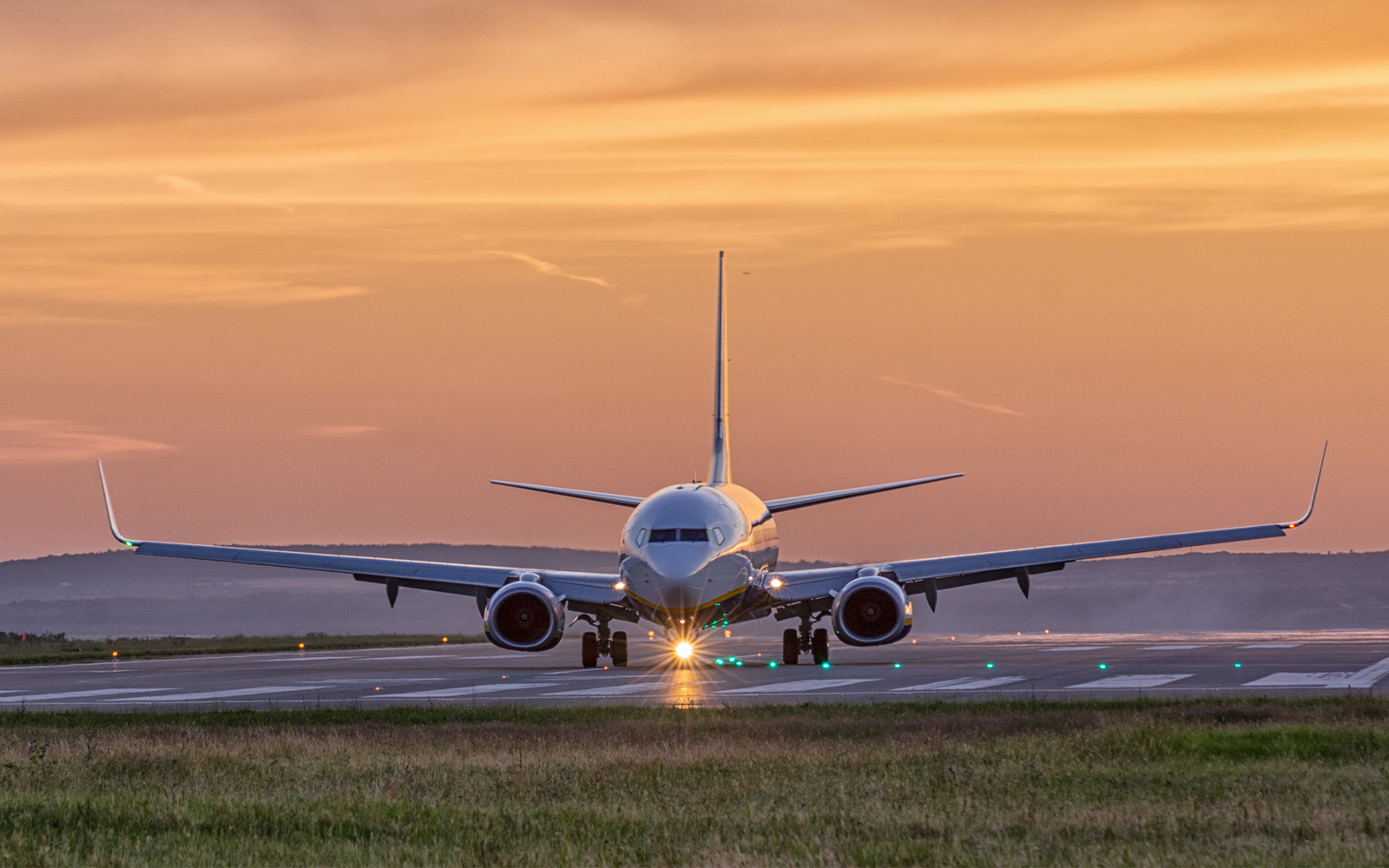 airplane landing at sunset