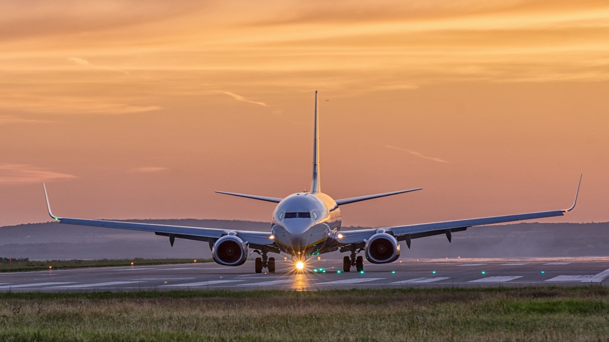 airplane landing at sunset