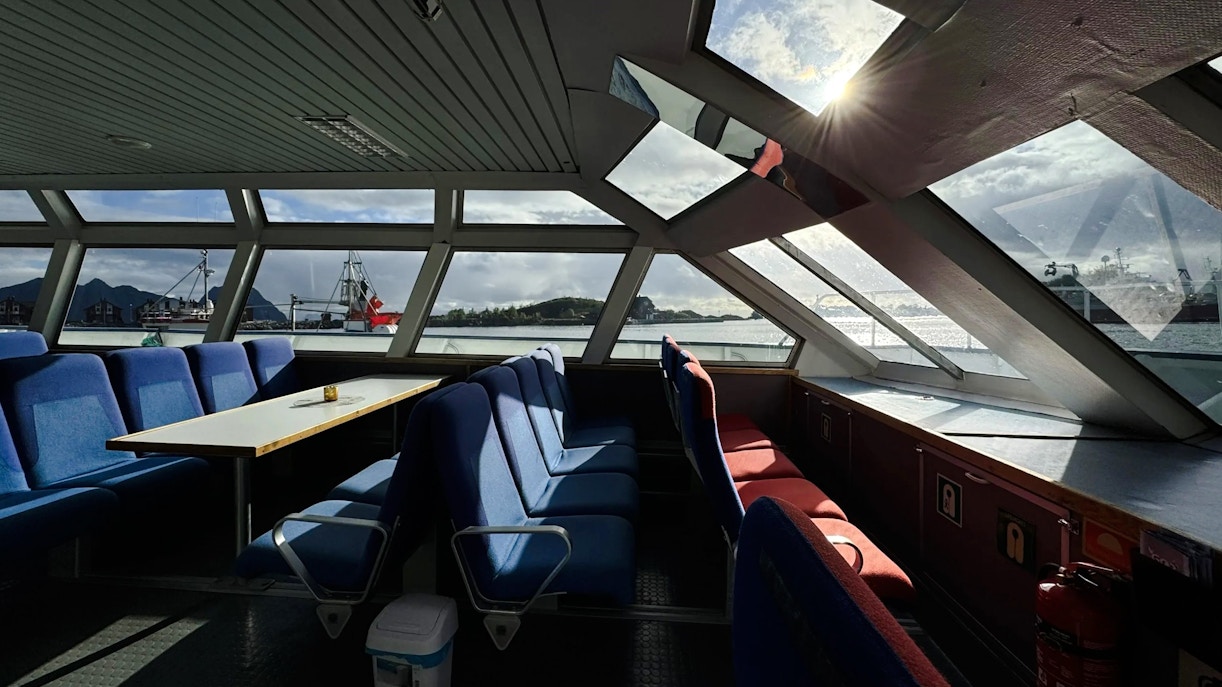 Interior view of Trollfjord cruise ship with seating and large windows, Lofoten.
