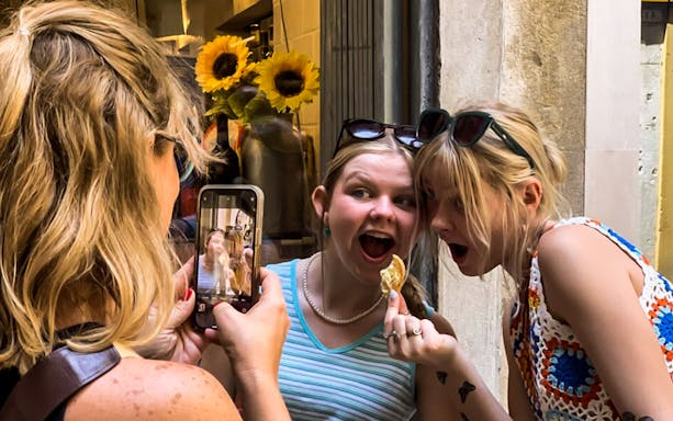 Tourists enjoying street food during a guided Venice Rialto Market tour.
