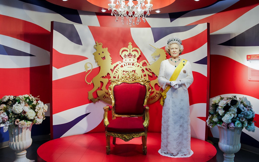 Wax figure of Queen Elizabeth with a royal backdrop at Madame Tussauds Bangkok.