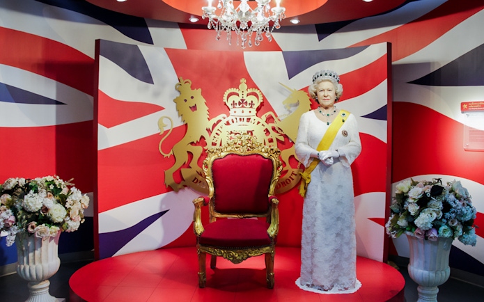 Wax figure of Queen Elizabeth with a royal backdrop at Madame Tussauds Bangkok.