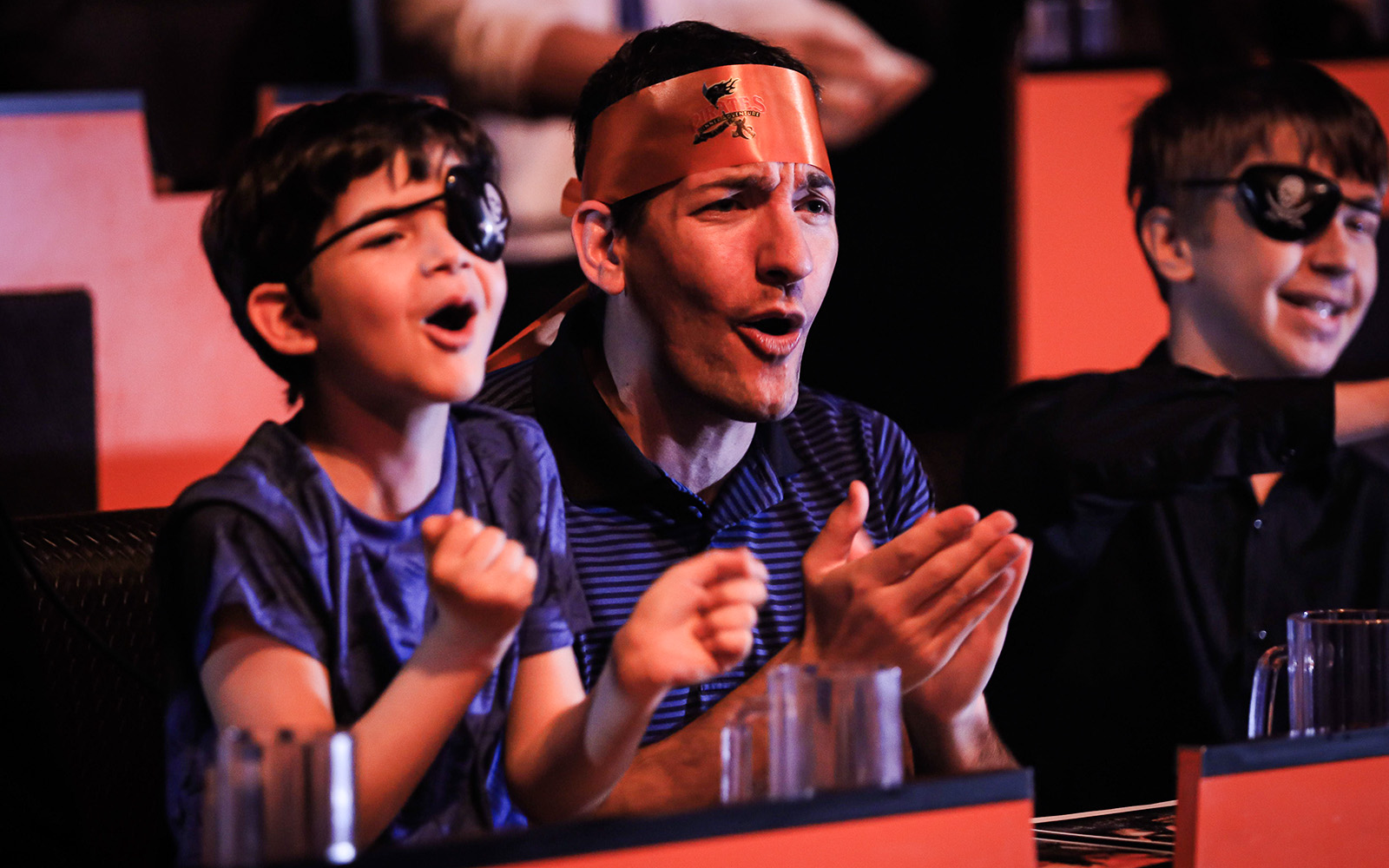 Guests cheering at Pirates Dinner Adventure Show.