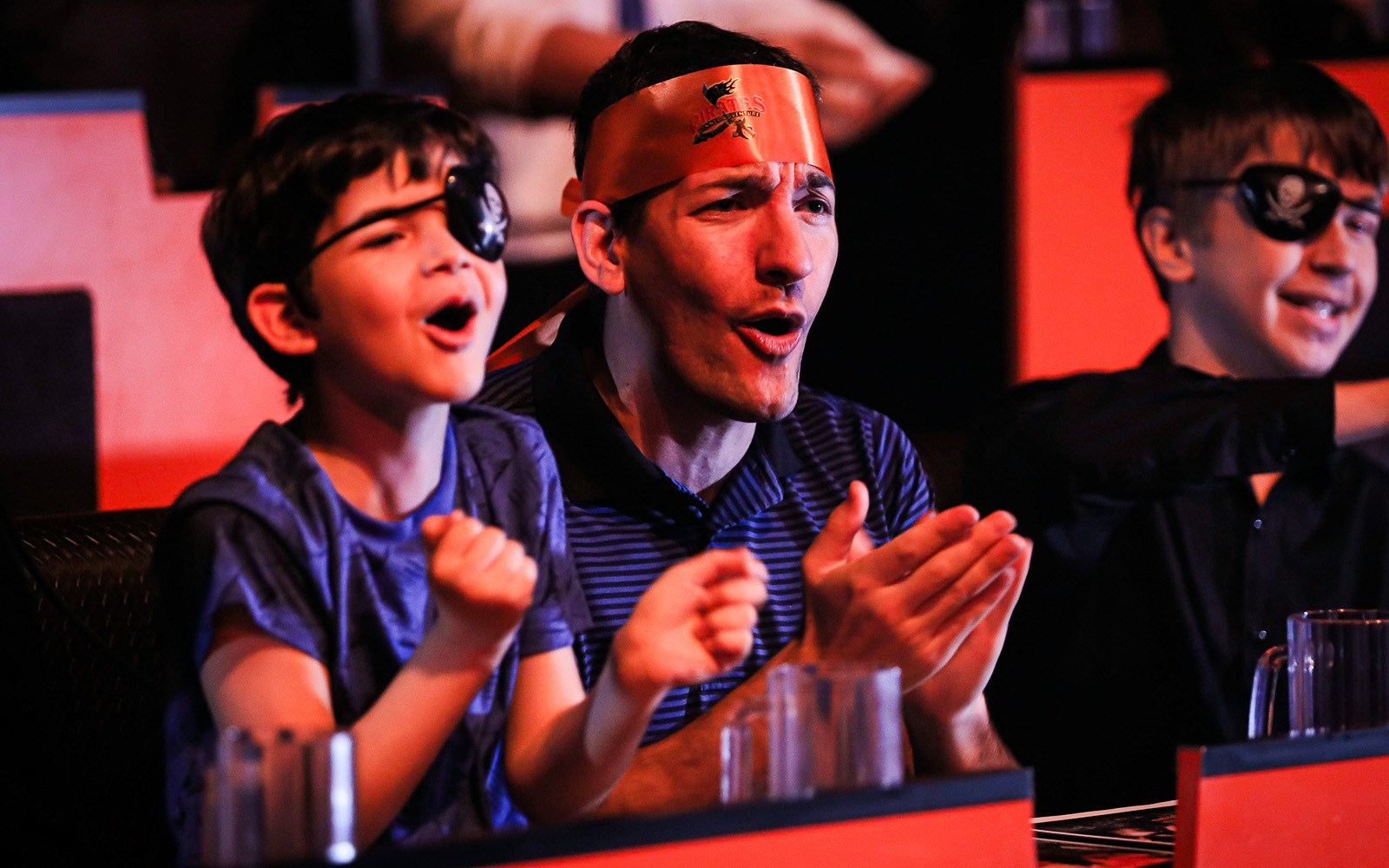 Guests cheering at Pirates Dinner Adventure Show.