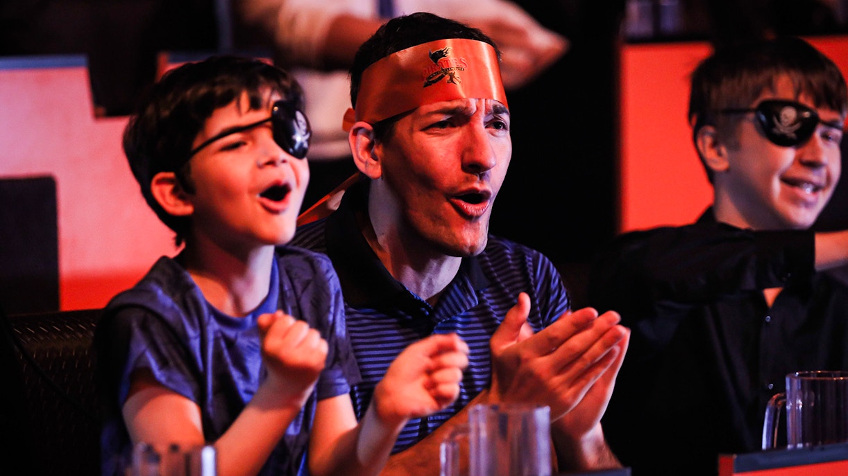 Guests cheering at Pirates Dinner Adventure Show.
