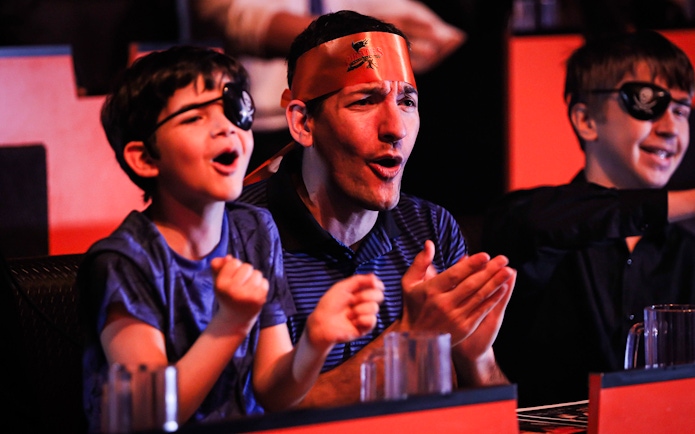 Guests cheering at Pirates Dinner Adventure Show.