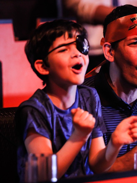 Guests cheering at Pirates Dinner Adventure Show.