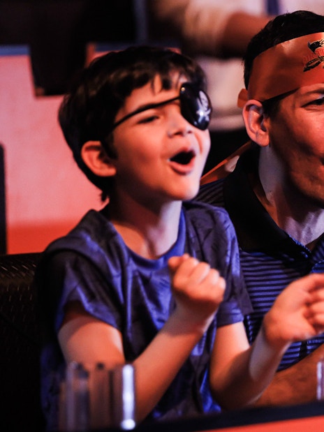 Guests cheering at Pirates Dinner Adventure Show.