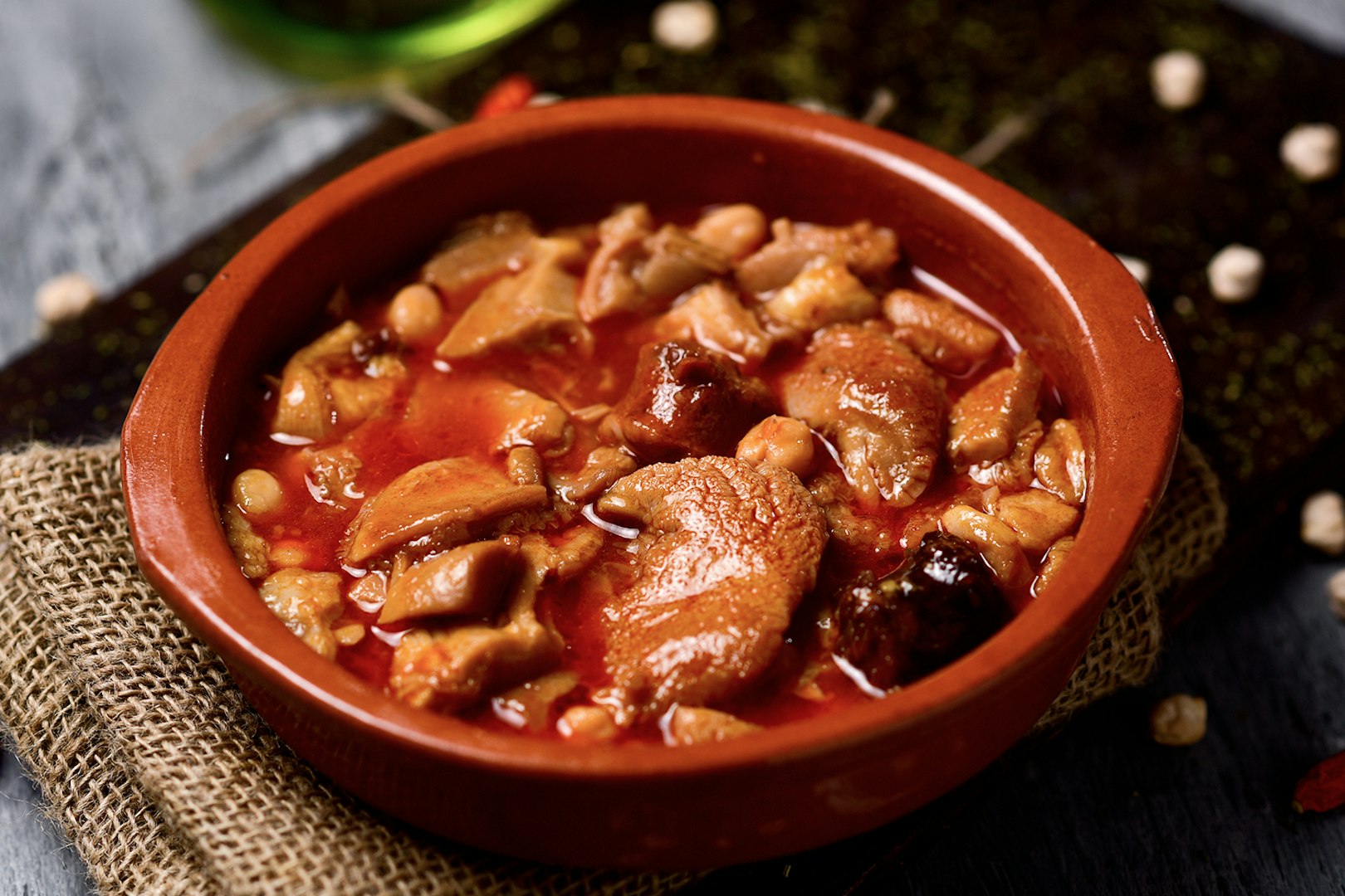 Traditional Spanish stew in a clay dish, part of a Flamenco and tapas tour in Triana.