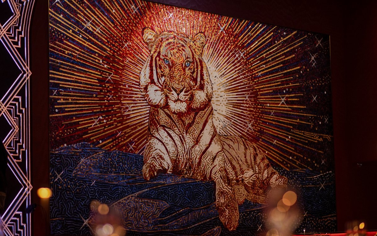 Tiger mosaic artwork at Paris Paradis with radiant background.