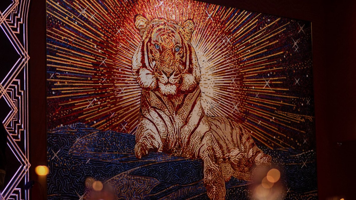 Tiger mosaic artwork at Paris Paradis with radiant background.