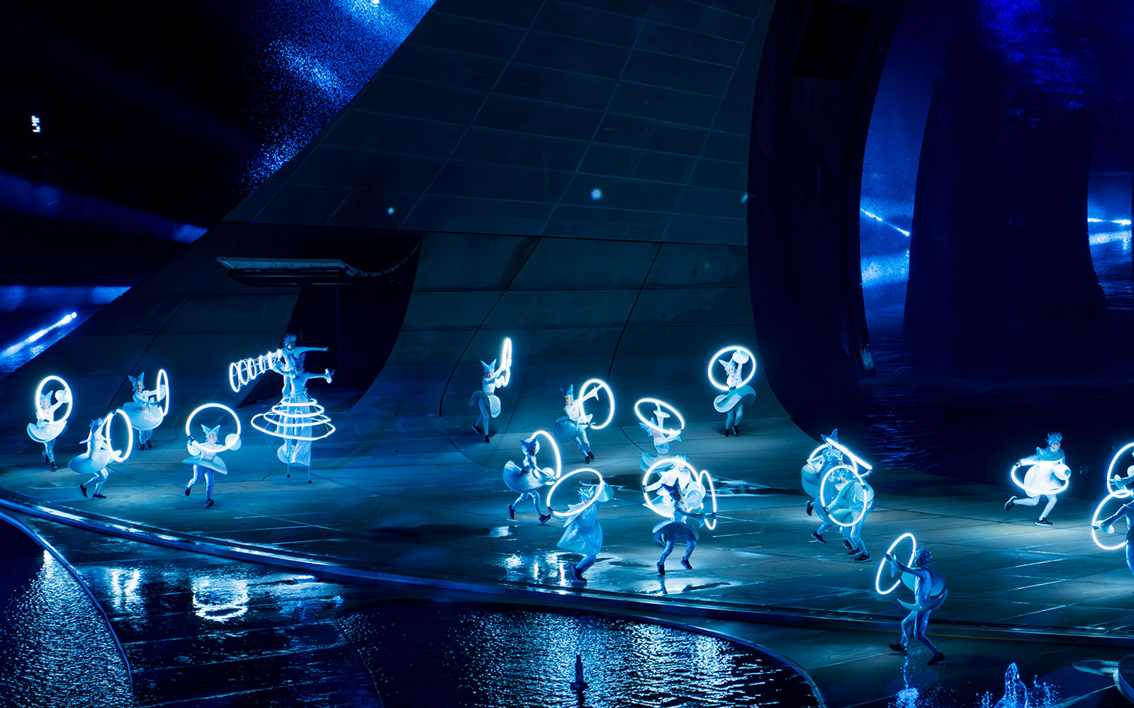 Performers with illuminated costumes in the Kiss of the Sea Show.