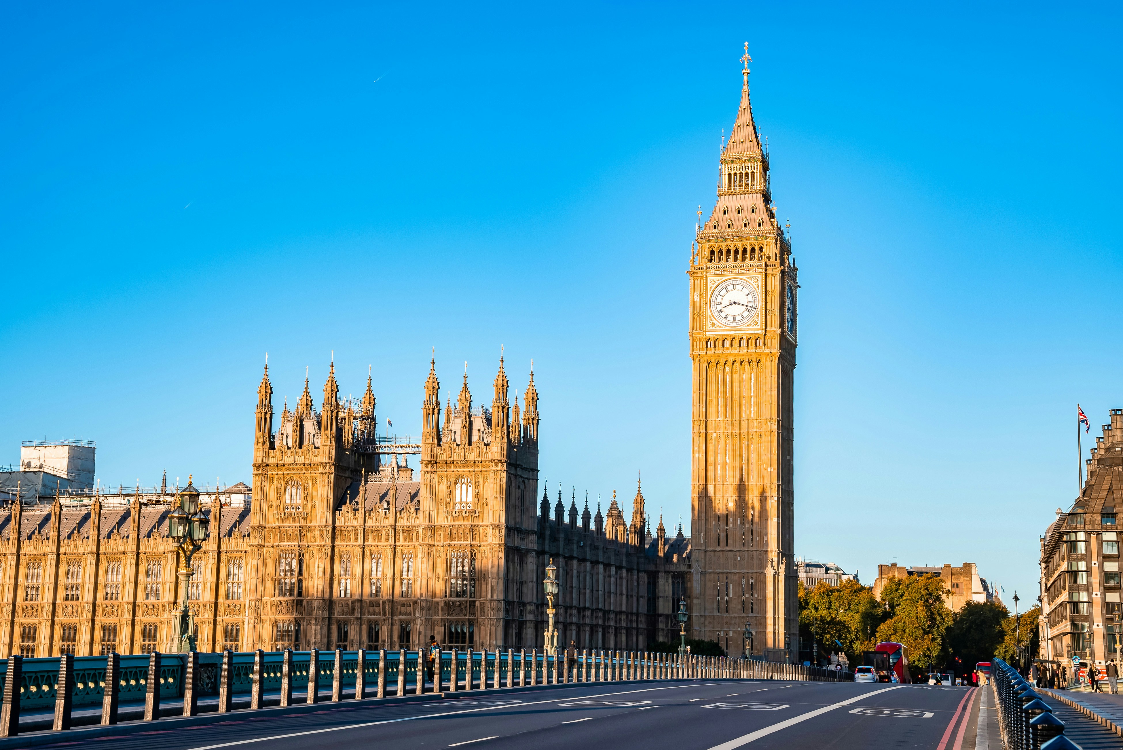 Big Ben and Houses of Parliament in London under a clear blue sky.