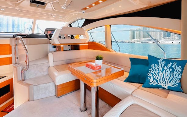 Luxurious yacht interior with seating area and sea view, Dubai.
