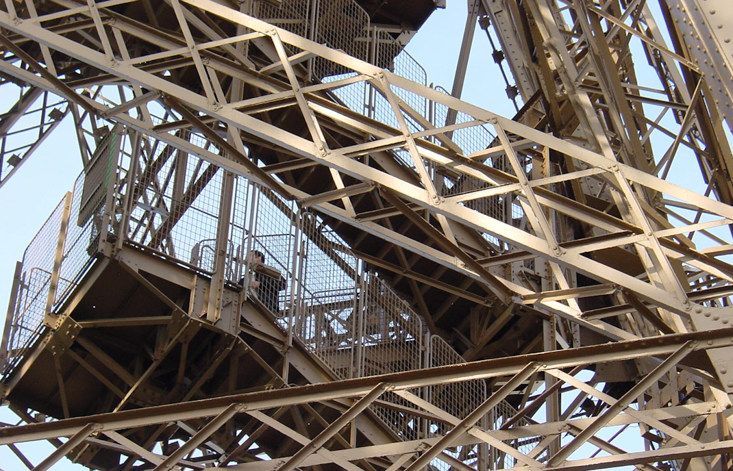 Eiffel Tower stairs with metal framework in Paris.